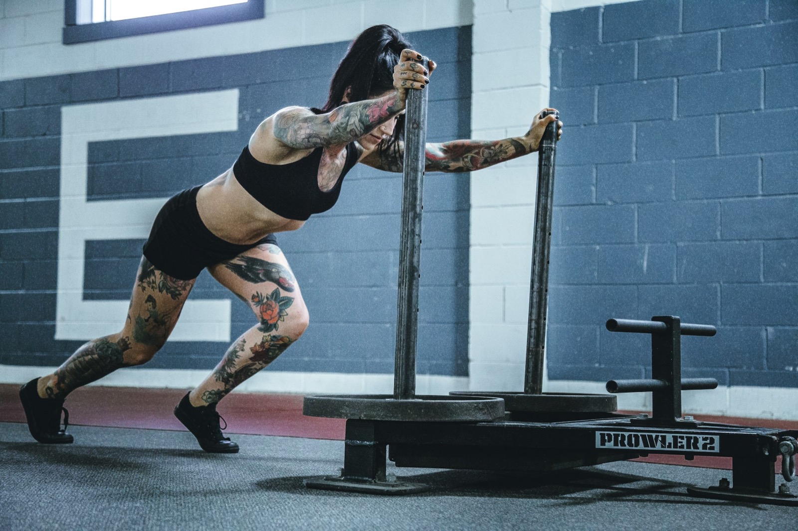 Athlete working battle ropes in an evening conditioning session